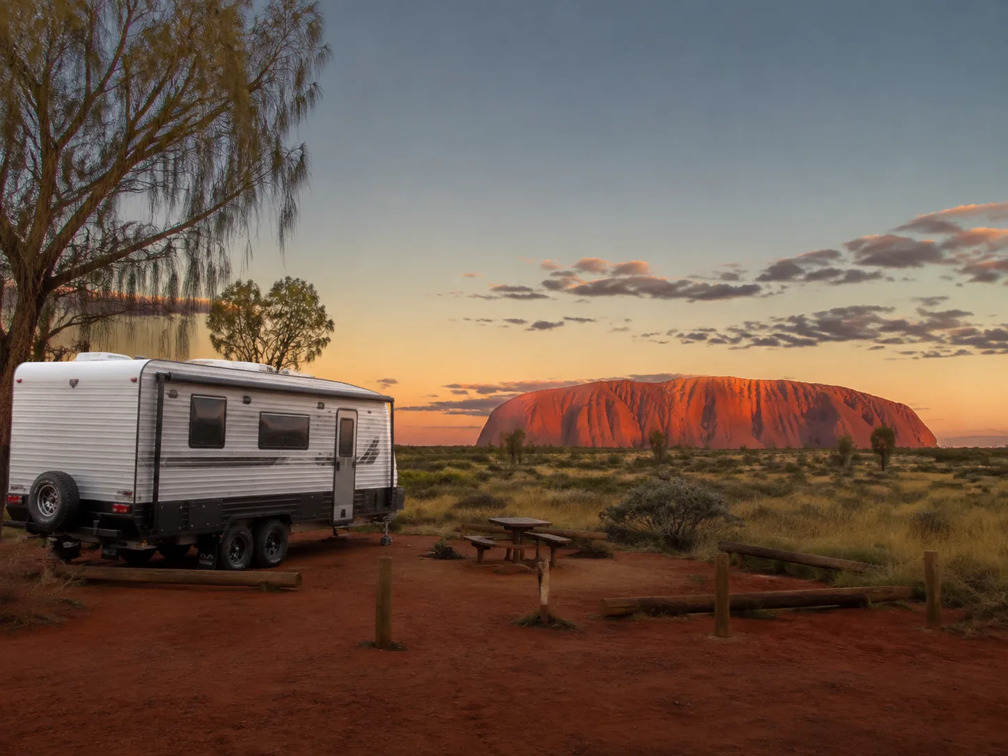 Caravan parked near Uluru in the evening light