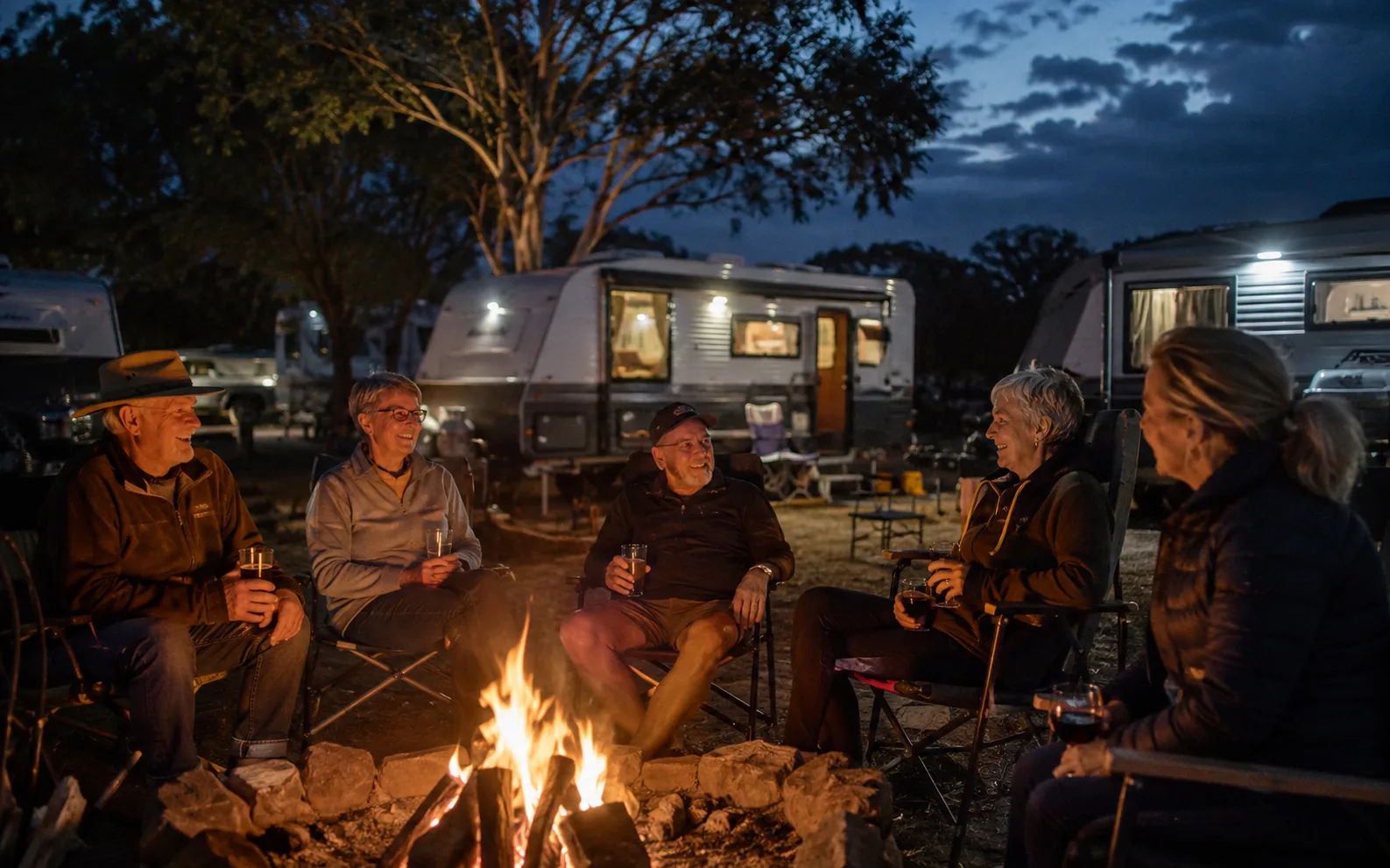 Caravan travellers sharing an evening around a campfire