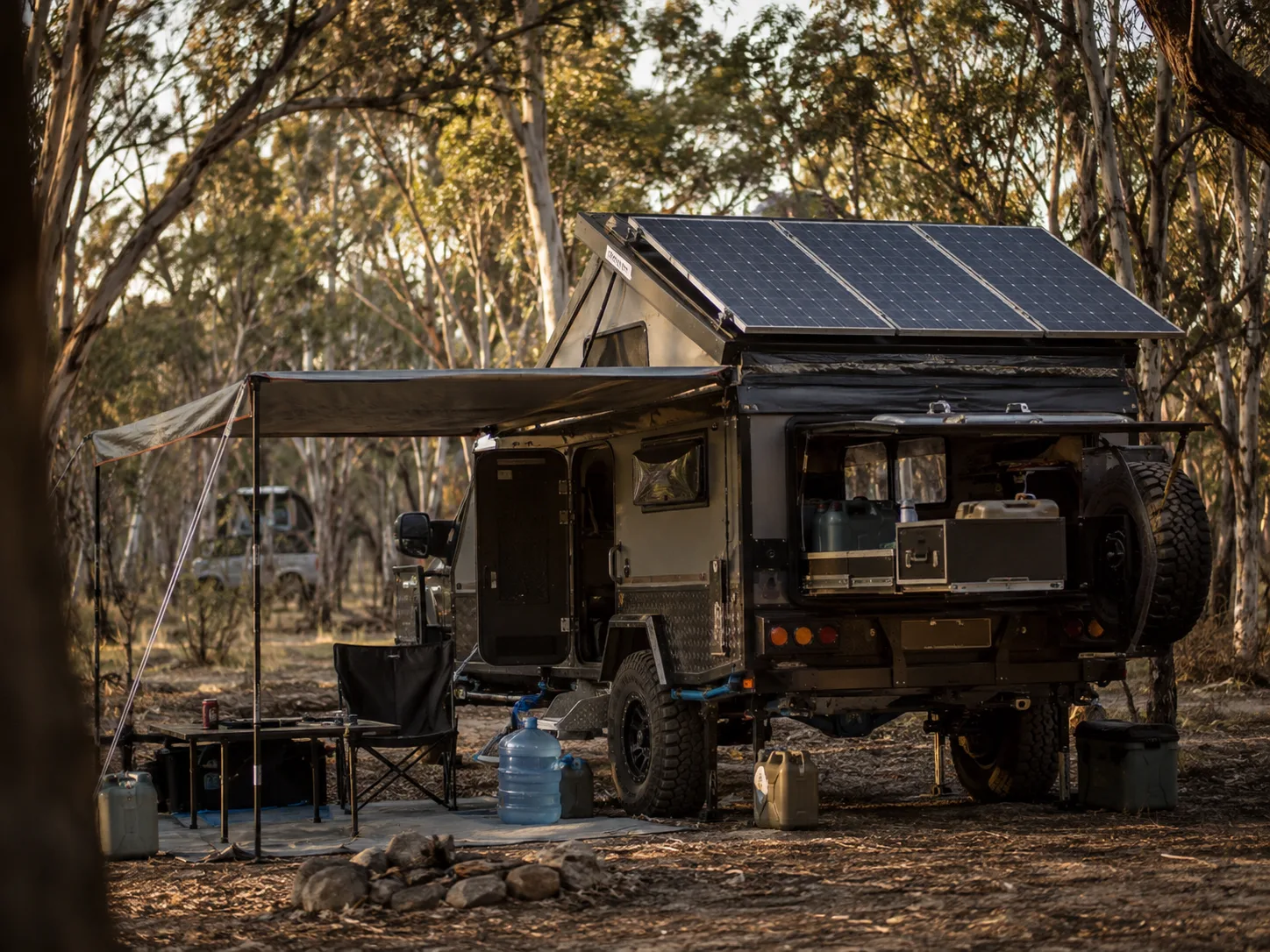 Off-road caravan with solar panels at a bush campsite